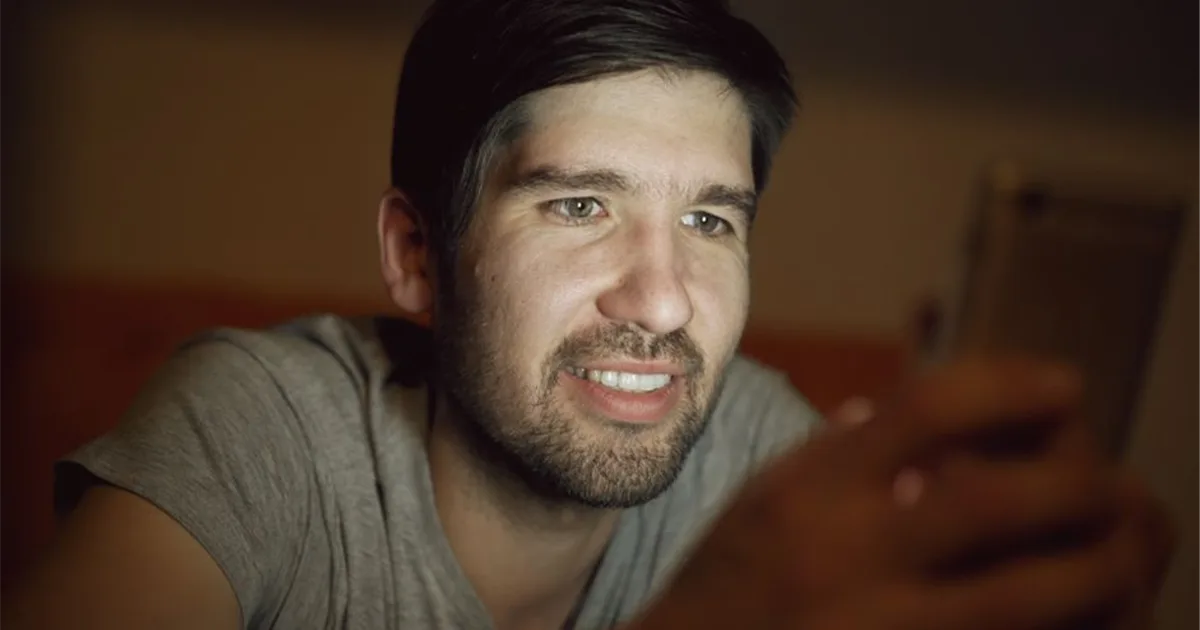 Man checking a 24/7 e-transfer payday loan application in the evening