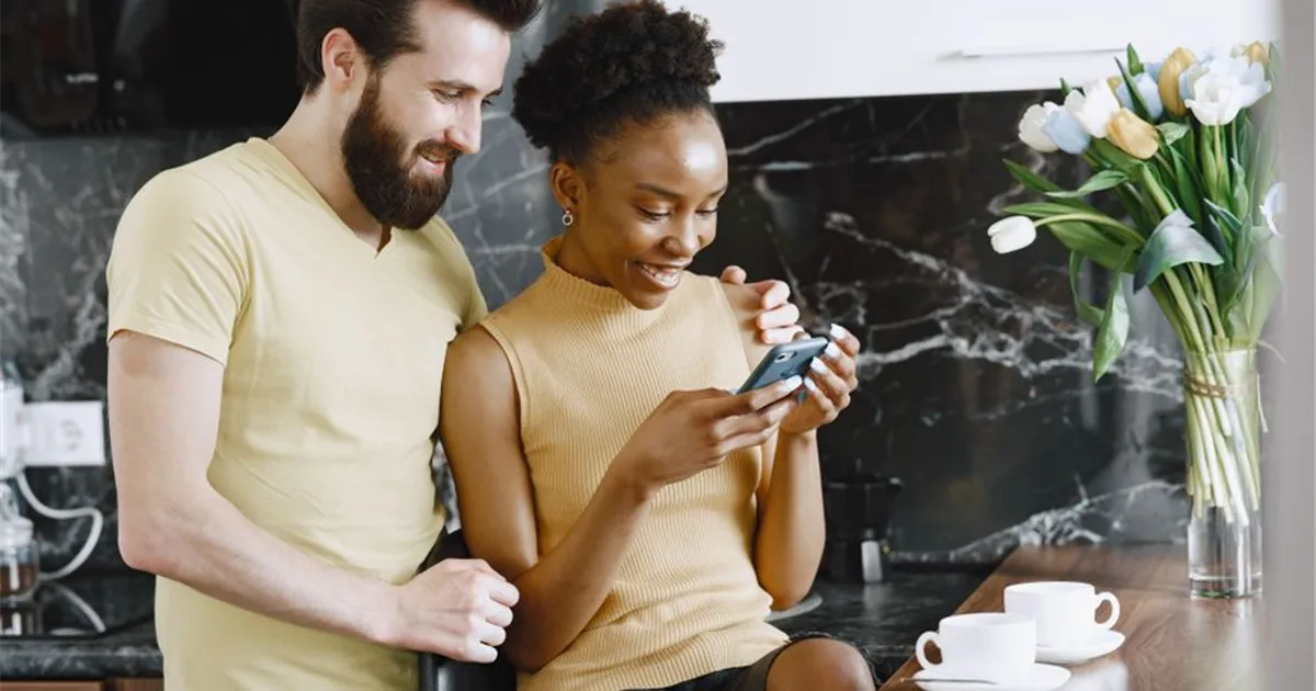 Couple seeing an Interac e-Transfer arrive after payday loan approval