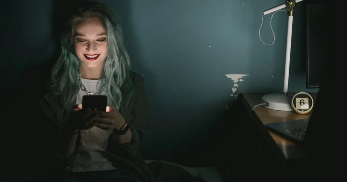 Woman receiving e-transfer payday loans Canada funds on her phone at night