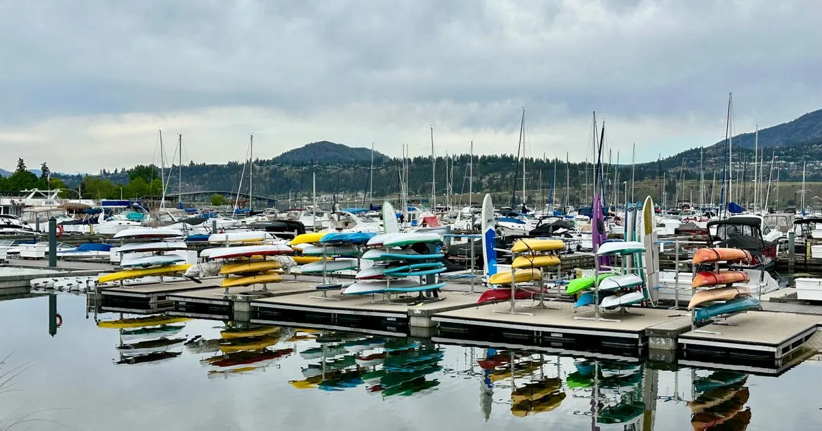 Kelowna marina on Okanagan Lake with kayaks and mountains - payday loans Kelowna